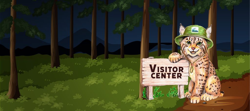 Bobby the bobcat welcomes visitors beside a Visitor Center sign in an Appalachian forest